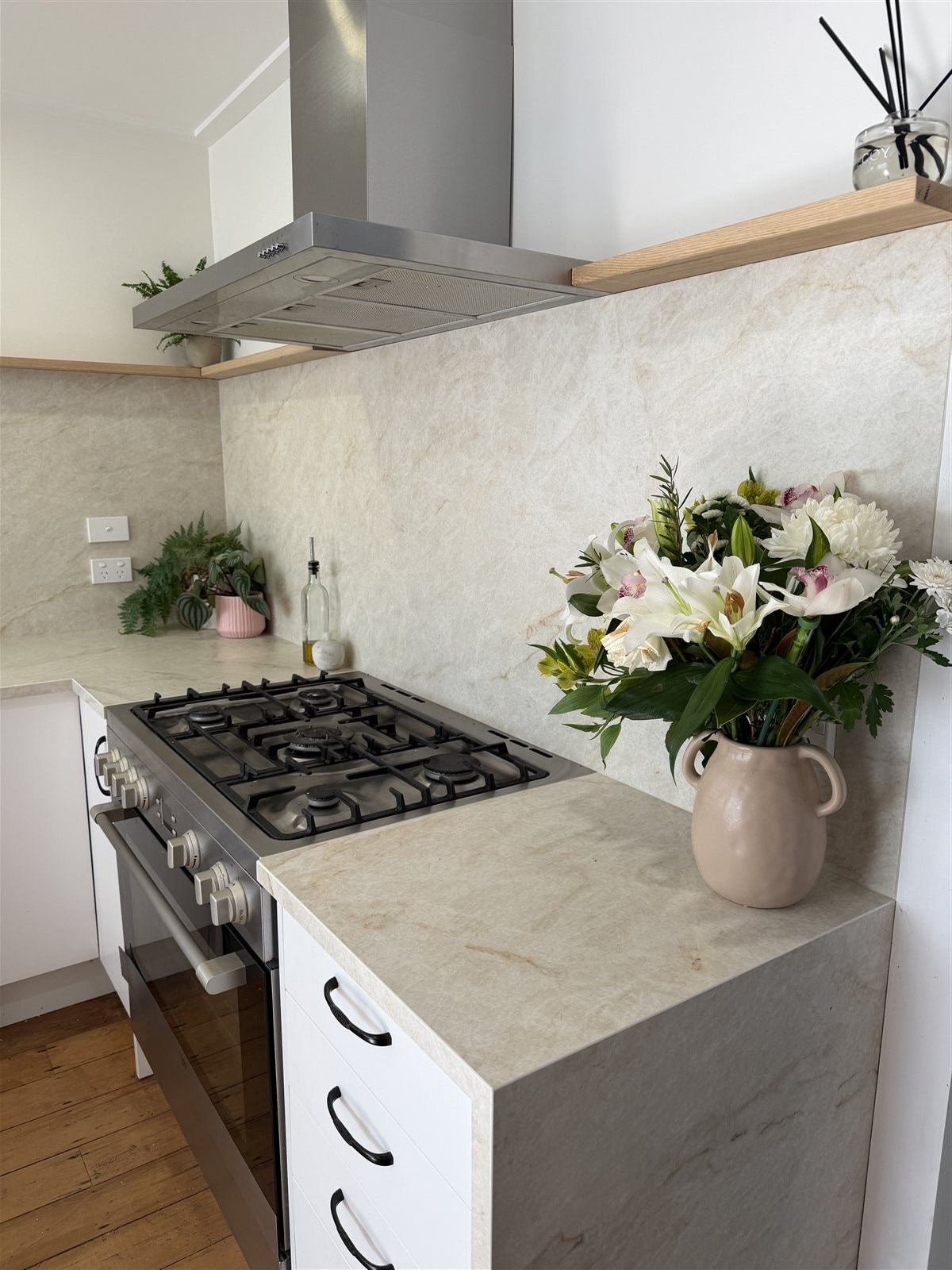Freestanding range cooker with stone splashback and custom cabinetry