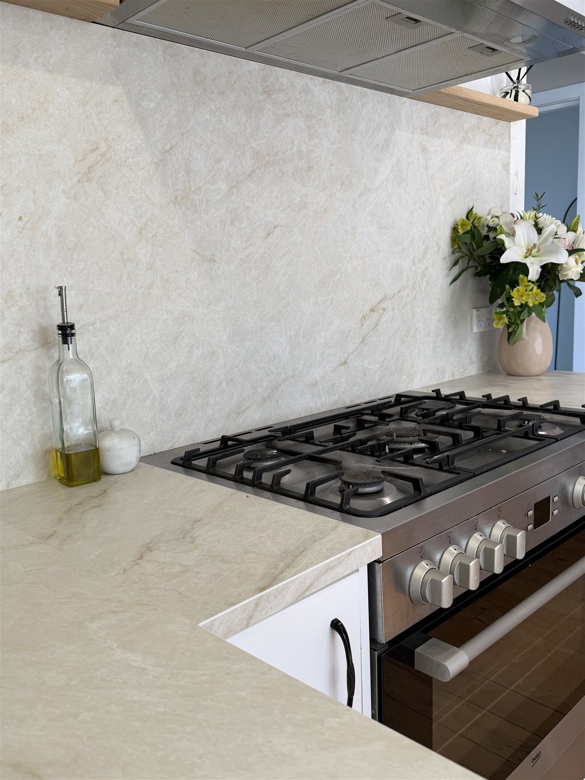 Detail of stone splashback and range cooker
