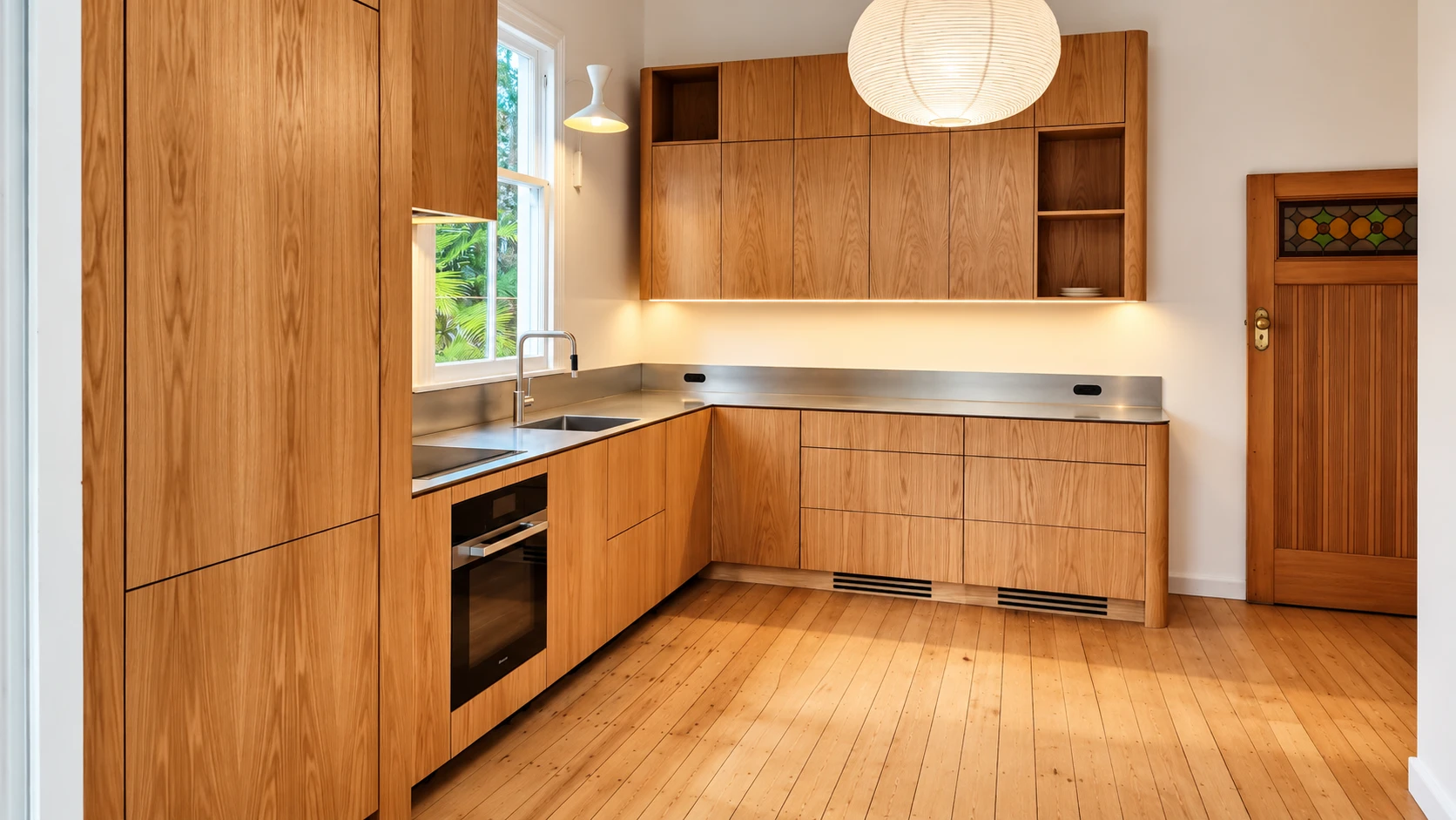Grey Lynn kitchen — full-height oak cabinetry with 5mm orbital satin-finish stainless steel benchtops in a heritage villa