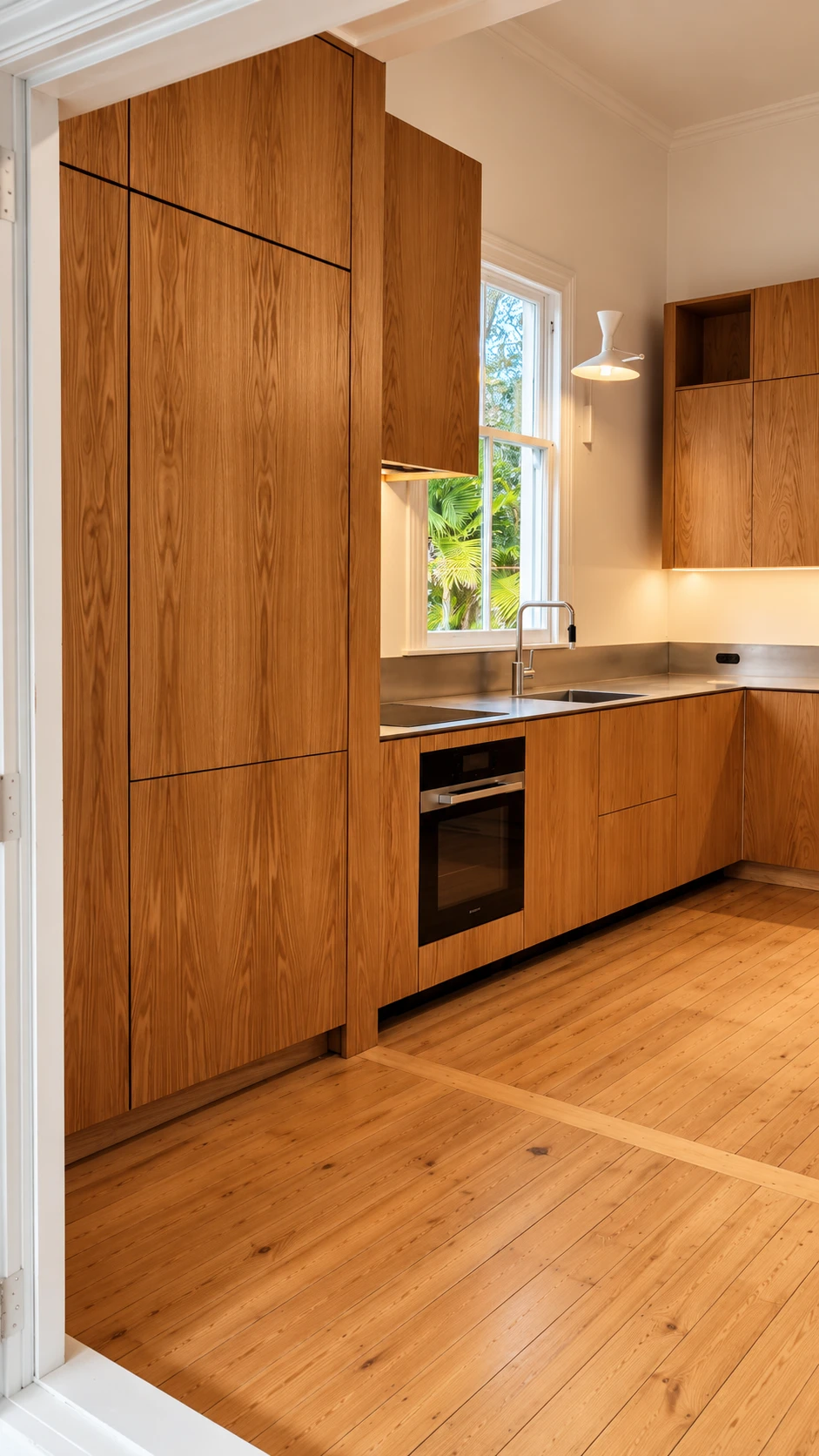 Grey Lynn heritage kitchen — full-height oak pantry tower, L-shaped layout with 5mm orbital satin-finish stainless steel benchtop